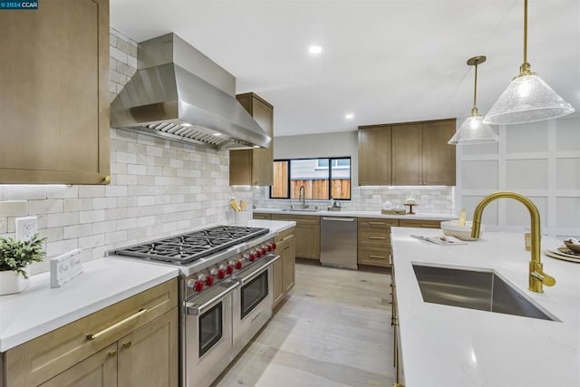 kitchen with sink, hanging light fixtures, stainless steel appliances, and exhaust hood