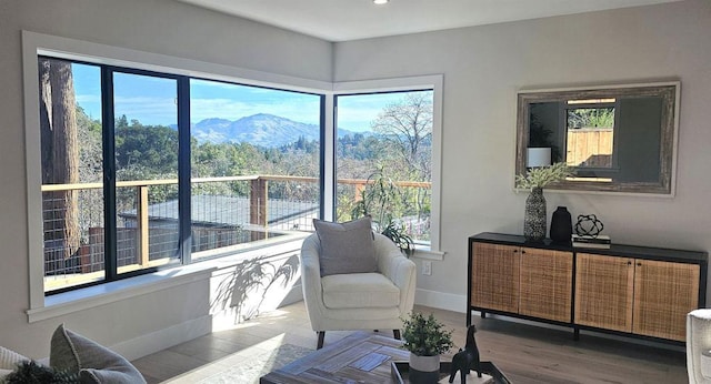 sitting room featuring a mountain view and hardwood / wood-style flooring