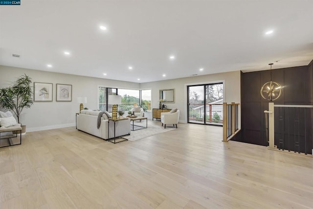 living room with a chandelier and light wood-type flooring