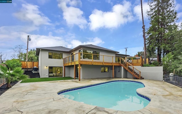 rear view of house featuring a swimming pool side deck and a patio area