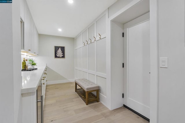 mudroom with light hardwood / wood-style floors