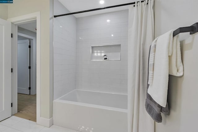 bathroom featuring shower / tub combo and tile patterned flooring