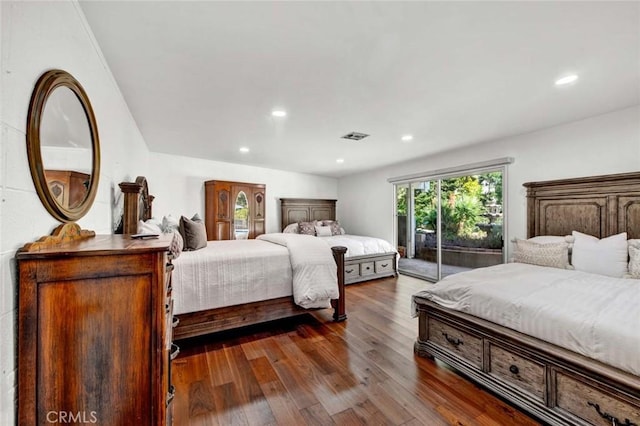 bedroom featuring access to exterior and dark hardwood / wood-style floors