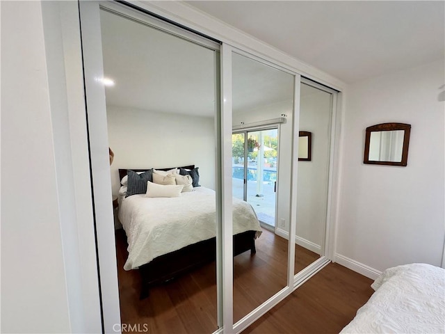 bedroom featuring access to exterior and dark hardwood / wood-style floors