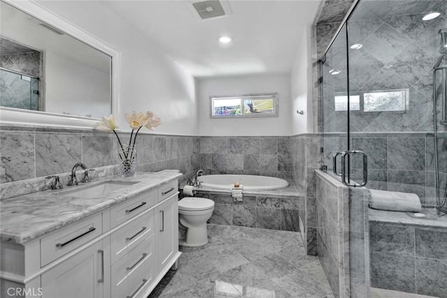 full bathroom featuring toilet, vanity, and independent shower and bath