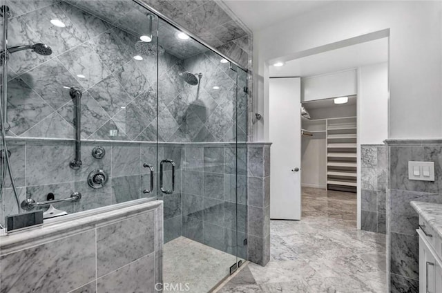 bathroom featuring vanity, tile walls, and an enclosed shower