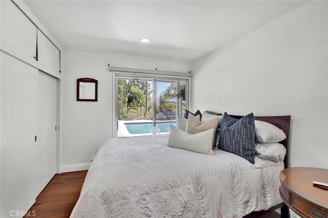 bedroom with dark hardwood / wood-style flooring and access to outside