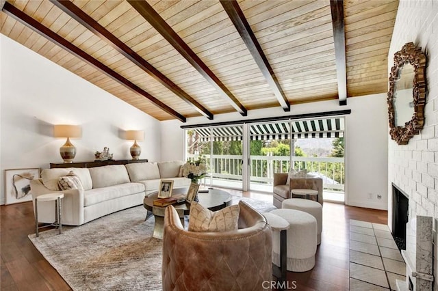 living room with wooden ceiling, dark hardwood / wood-style floors, a brick fireplace, and beamed ceiling