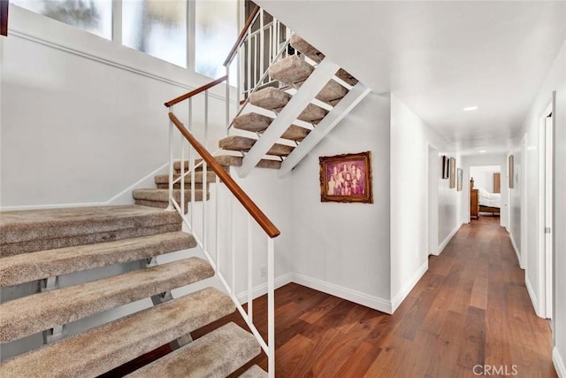 staircase with wood-type flooring