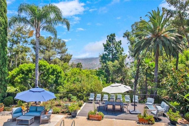 view of property's community featuring a deck and outdoor lounge area