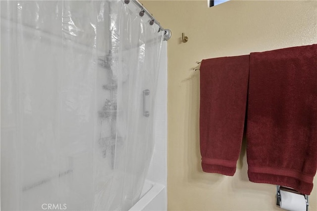 bathroom featuring shower / tub combo with curtain