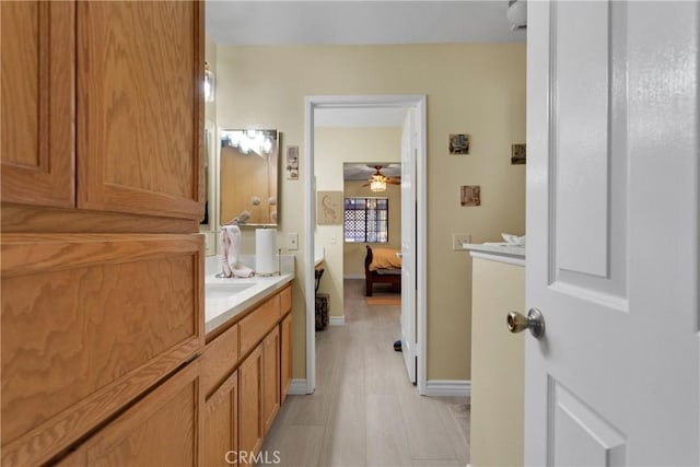 bathroom with ceiling fan and vanity