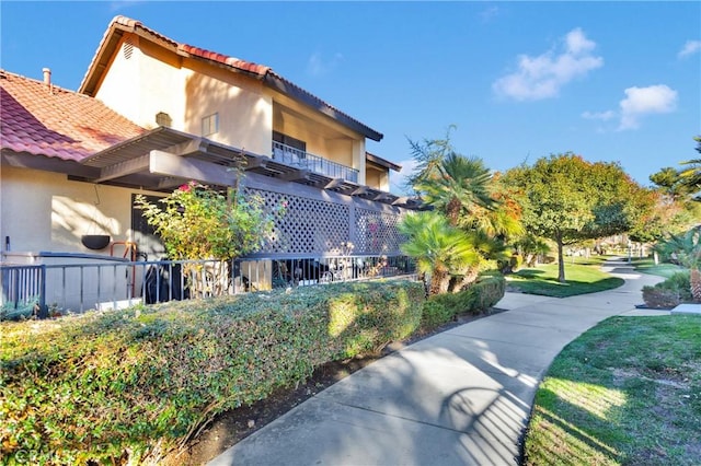 view of side of home featuring a balcony