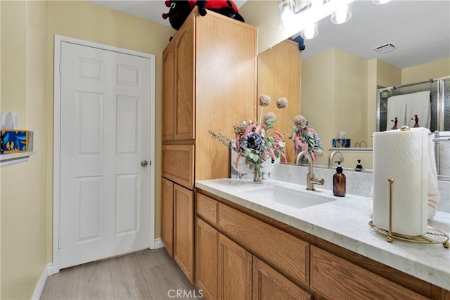 bathroom with hardwood / wood-style flooring and vanity