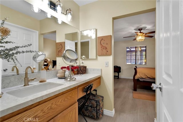 bathroom with ceiling fan, vanity, and hardwood / wood-style flooring