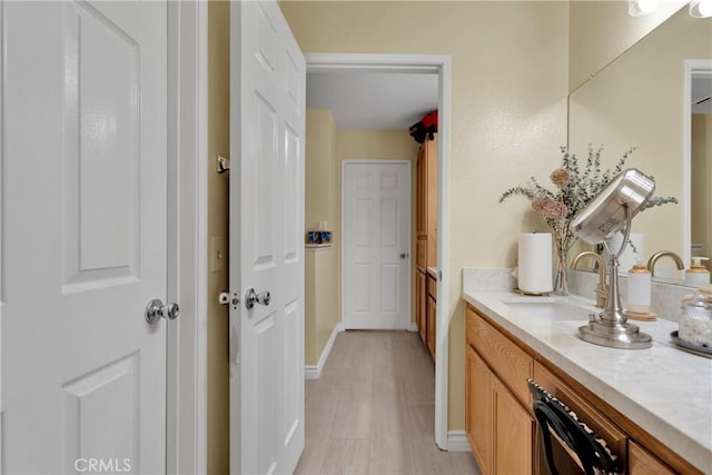 bathroom featuring wood-type flooring and vanity