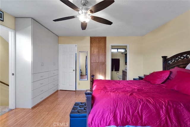 bedroom with ceiling fan, connected bathroom, and light wood-type flooring