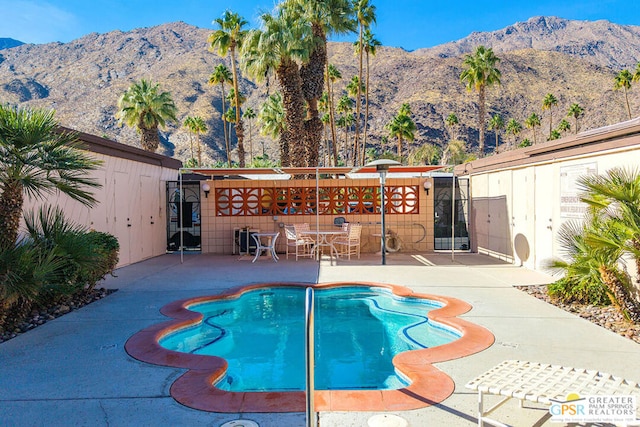 view of pool featuring a mountain view and a patio area