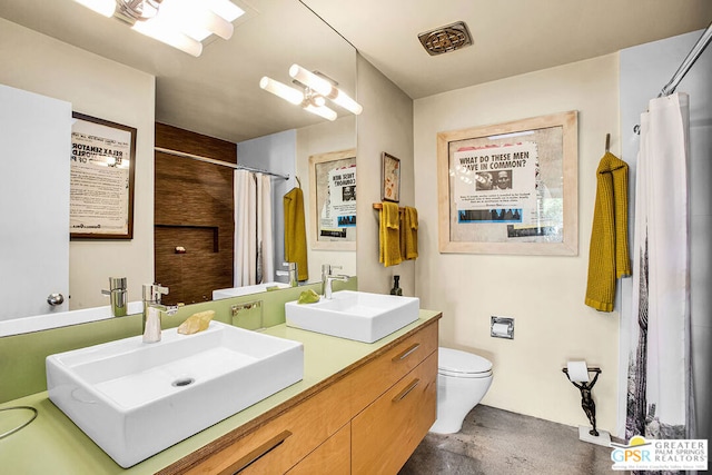 bathroom with concrete flooring, vanity, walk in shower, and toilet