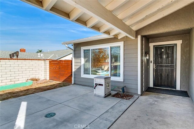 entrance to property featuring a patio