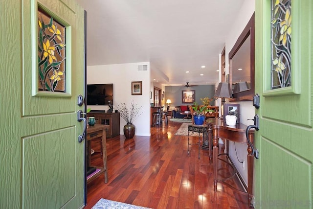 entrance foyer with ceiling fan and dark wood-type flooring