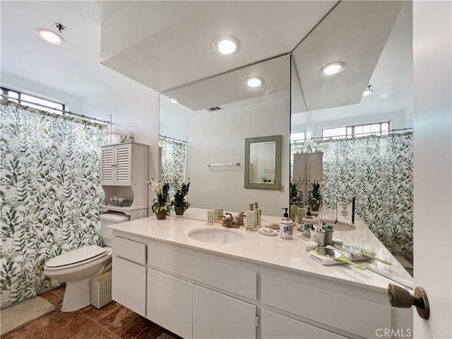 bathroom featuring vanity and toilet