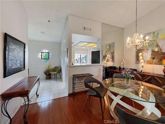 dining room featuring lofted ceiling, hardwood / wood-style floors, and a wealth of natural light