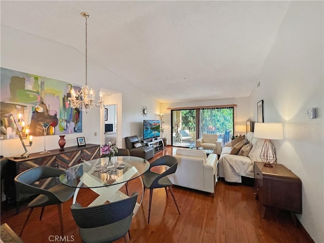 dining space with hardwood / wood-style flooring, vaulted ceiling, and a notable chandelier