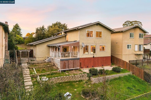 view of back house at dusk