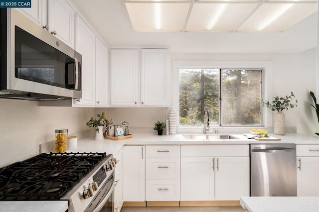 kitchen featuring white cabinets, sink, and appliances with stainless steel finishes