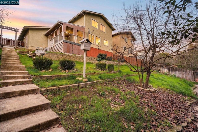 yard at dusk with a balcony