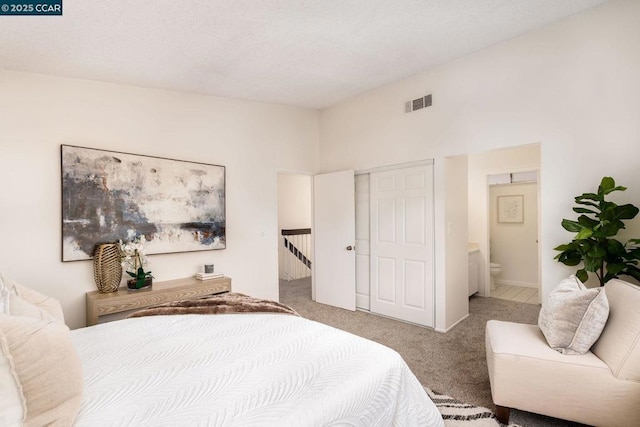 carpeted bedroom with ensuite bathroom