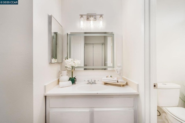 bathroom with vanity and toilet