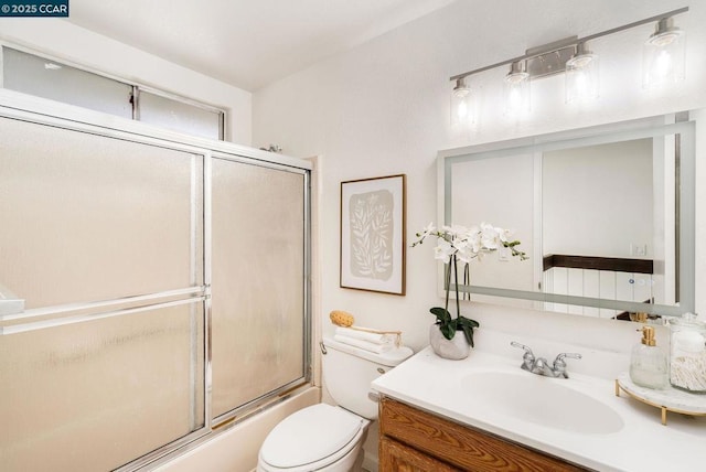 full bathroom featuring shower / bath combination with glass door, vanity, and toilet