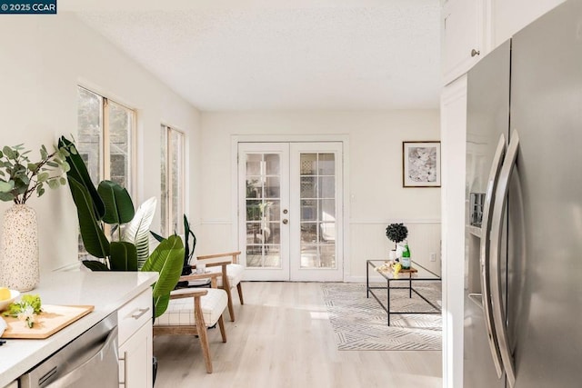 interior space with french doors and light hardwood / wood-style floors