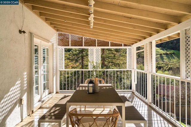 sunroom with a healthy amount of sunlight and lofted ceiling