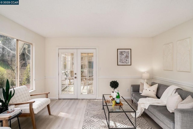 living room with french doors and light hardwood / wood-style floors