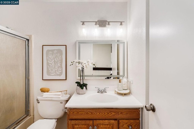 bathroom featuring vanity, toilet, and an enclosed shower