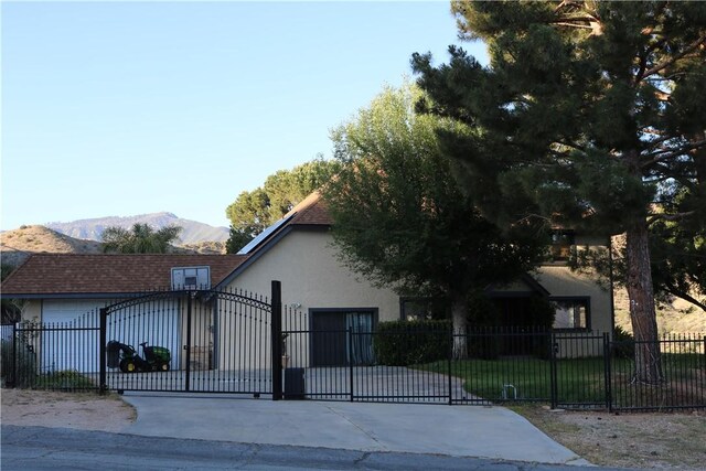 view of gate featuring a mountain view and a garage