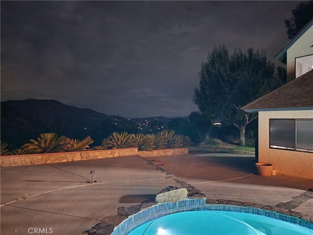 pool at twilight with a mountain view