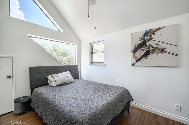 bedroom featuring high vaulted ceiling and dark hardwood / wood-style floors