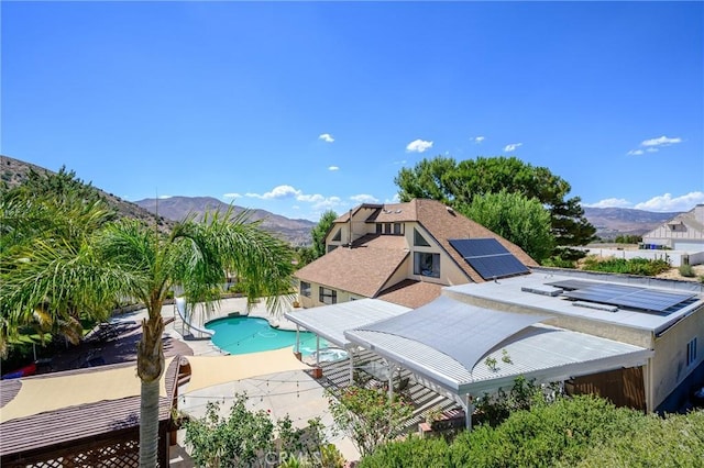 view of pool featuring a mountain view, a patio area, and a diving board