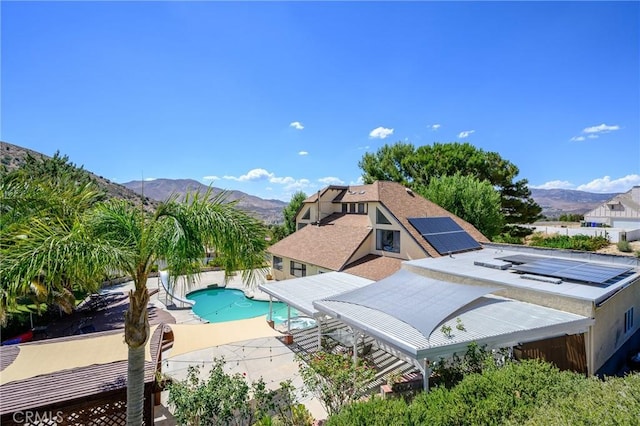 view of swimming pool featuring a mountain view and a diving board