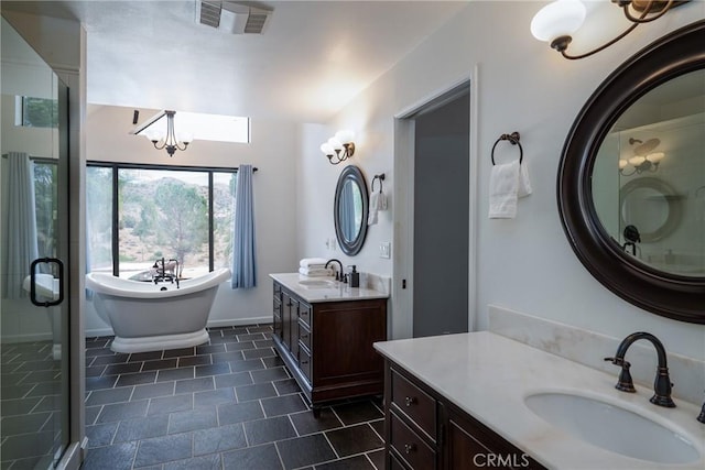 bathroom featuring independent shower and bath, a chandelier, and vanity