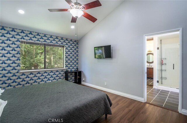 bedroom with ceiling fan, dark hardwood / wood-style flooring, connected bathroom, and high vaulted ceiling