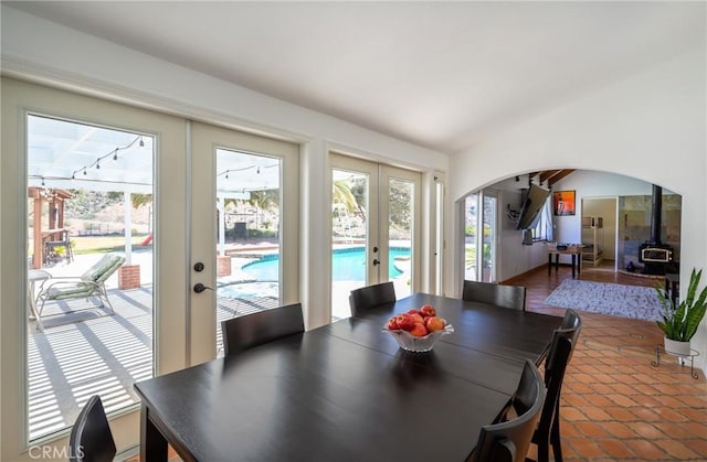 dining room featuring a wood stove and french doors