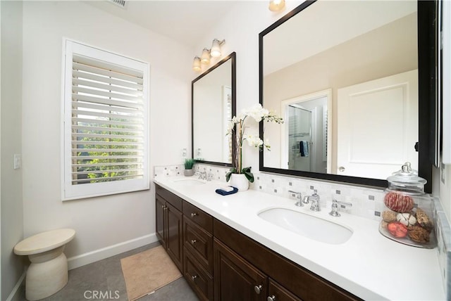 bathroom with vanity and tasteful backsplash