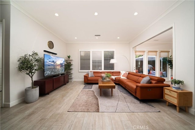 living room featuring ornamental molding and light wood-type flooring