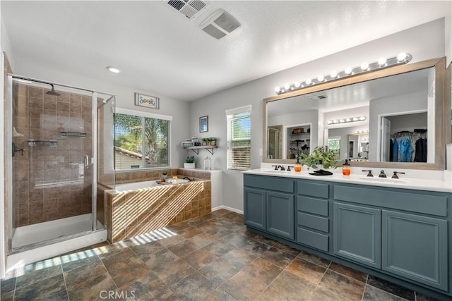 bathroom with vanity and independent shower and bath