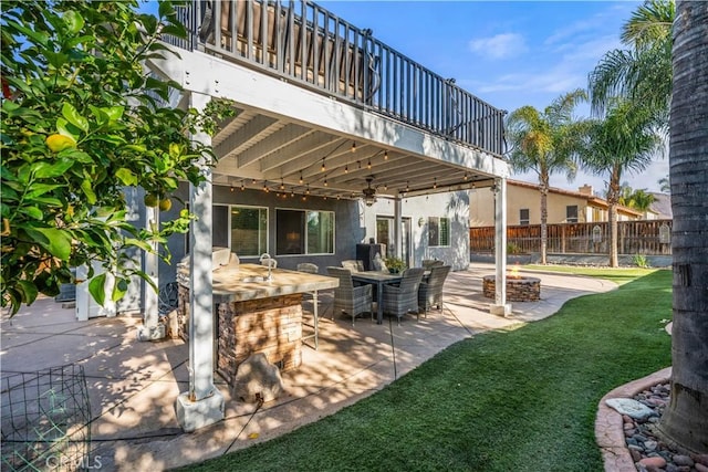 view of patio with a balcony, an outdoor bar, and ceiling fan